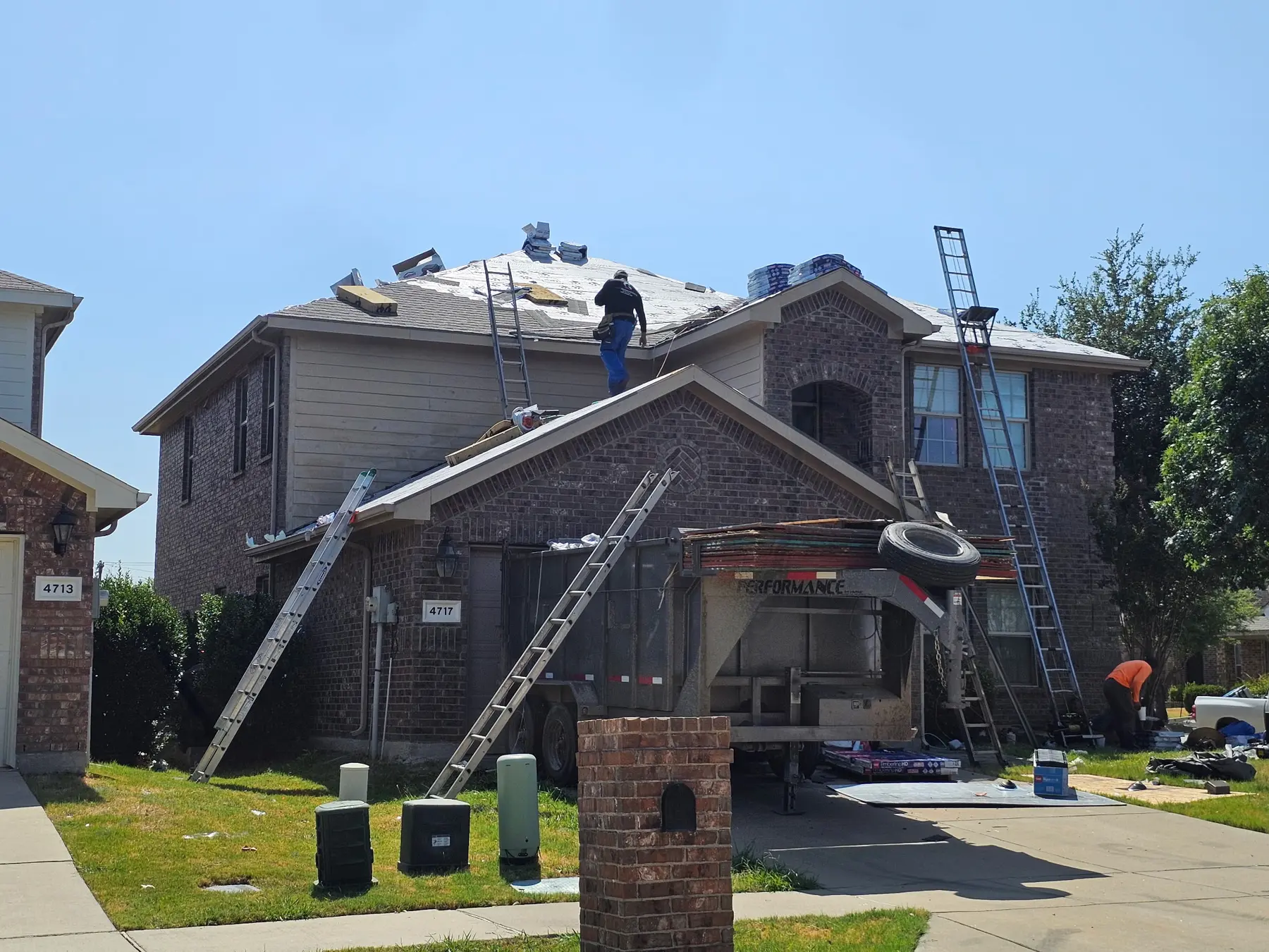 Residential roofing project underway with underlayment installed